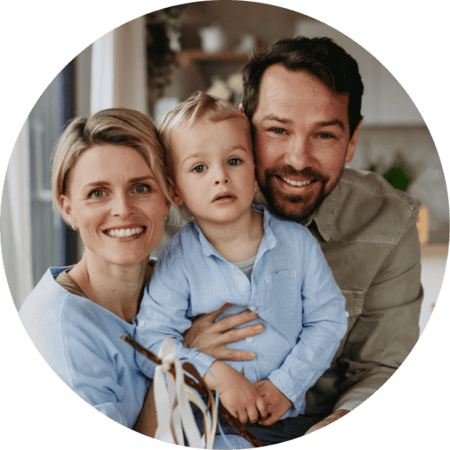Parents with child smiling and posing for family photoshoot